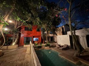 a swimming pool in front of a house at night at Casa Ramona in Mérida