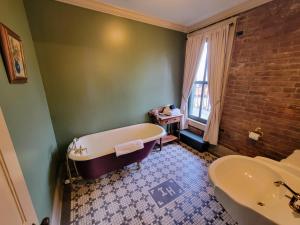 a bathroom with a bath tub and a sink at Iron Horse Hotel in Blackwater +60 photos