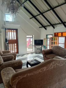 a living room with two couches and a tv at Amplio Apartamento en San Cristóbal con AC, Casa Oasis Galápagos in Puerto Baquerizo Moreno
