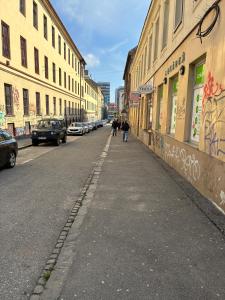 two people walking down a city street with buildings at Residence 1892 - Apartment 3 in Bratislava