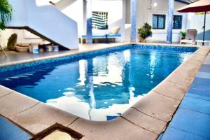 a swimming pool with a slide in a building at La belle vie in Rufisque