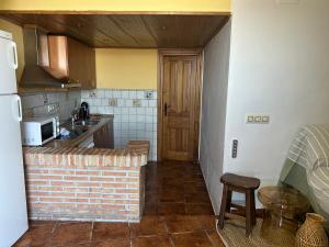 a kitchen with a sink and a counter top at Casita El Granero in Iznatoraf +6 photos