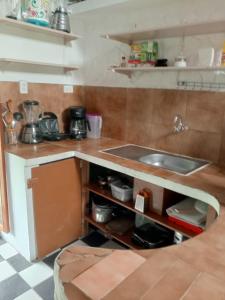 a small kitchen with a sink and a counter at Amplio Apartamento en San Cristóbal con AC, Casa Oasis Galápagos in Puerto Baquerizo Moreno +17 photos