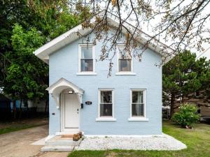 a blue house with a white door at Hot Tub 5 Mins from Cedar Point Modern Updates in Sandusky