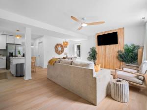 a living room with a couch and a kitchen at Hot Tub 5 Mins from Cedar Point Modern Updates in Sandusky +55 photos