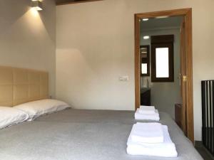 a bedroom with two beds with white towels on the floor at Alojamiento con terraza en Chulilla in Chulilla