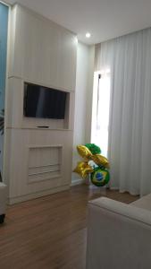 a living room with a flat screen tv on a wall at Flat colado a praia de Boa Viagem in Recife