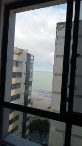 a view from a window of a beach and buildings at Flat colado a praia de Boa Viagem in Recife