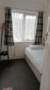 a small bedroom with a bed and a window at Zoran home 3 in Leicester