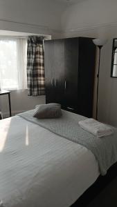 a bedroom with a large bed with two pillows on it at Zoran home 3 in Leicester