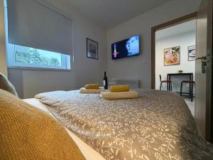 a bedroom with a large bed with two pillows on it at Apartman Mali Muk 2, self check in in Karlovac