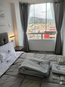 a bed in a bedroom with a large window at Hostal New York in Jauja