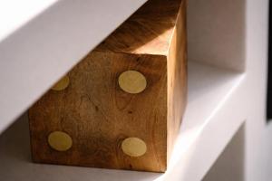 a wooden box with circles on it on a wall at Hotel PI Arte Exclusive Suite in Palermo