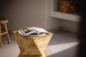 a wooden table with a book on top of it at Hotel PI Arte Exclusive Suite in Palermo +89 photos