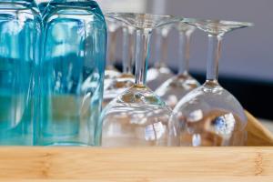 a group of wine glasses sitting on a table at FjordNest Cabin in Hvannasund +7 photos