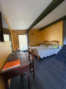 a room with two beds and a table and chairs at Camera di Molly in Leivi
