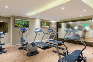 a gym with a bunch of cardio equipment in it at Hôtel Barrière Le Gray d'Albion in Cannes