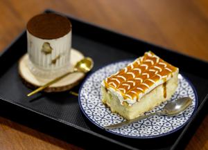 a piece of cake on a blue and white plate at Hotel Red Tower in Zugdidi
