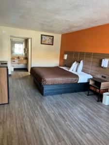a large hotel room with a bed and a table at Studios 4 Less Chesapeake in Chesapeake