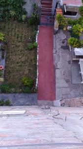 a red path in front of a building at Habitación Privada Centro in Ayacucho