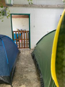 a large green umbrella in a room with a doorway at El Chirris Tzanjay in San Juan La Laguna