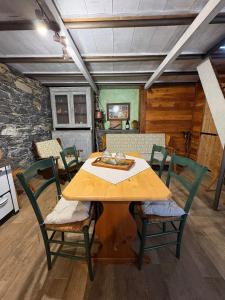 a dining room with a table and chairs at La Casetta di Molly tra ulivi e roseto in Leivi