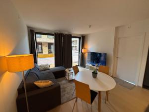 a living room with a couch and a table at Apartment in Central Røa Oslo by the Train Station in Oslo
