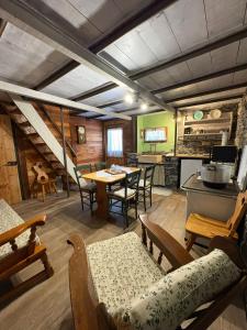 a kitchen and dining room with a table and chairs at La Casetta di Molly tra ulivi e roseto in Leivi