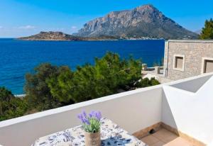a view of the ocean from the balcony of a house at Louis Studios and Apartments Melitsaha Beach in Kalymnos