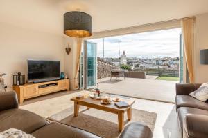 a living room with a couch and a television at 3 Bed in Brixham oc-57892 in Brixham