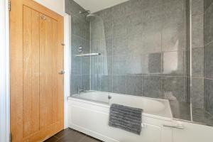 a bathroom with a tub and a glass shower at 3 Bed in Brixham oc-57892 in Brixham +32 photos