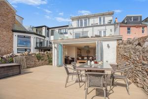 a patio with a table and chairs and a building at 3 Bed in Brixham oc-57892 in Brixham