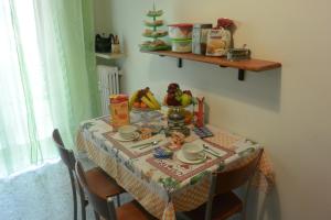 a dining room table with a table cloth with fruit on it at B&B Ganna in Verona