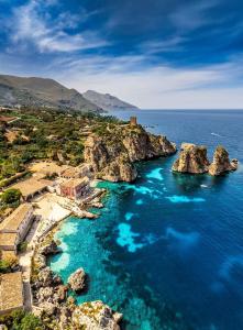 an aerial view of a rocky island in the ocean at Angolo Lamia Sicily Apartment in Partinico