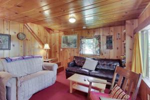 a living room with a couch and a table at Beth's Lakeside Cabin in McCall