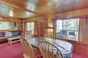 a dining room with a table and chairs and a couch at Beth's Lakeside Cabin in McCall