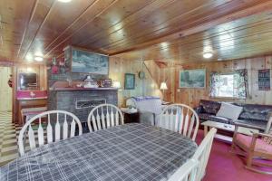 a living room with a table and a fireplace at Beth's Lakeside Cabin in McCall