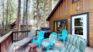 a deck with chairs and a grill on a cabin at Beth's Lakeside Cabin in McCall