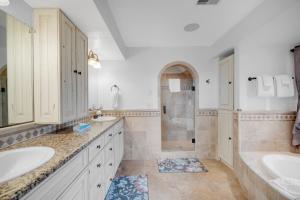 a white bathroom with two sinks and a shower at Fun w/ Family! Mtn-View Gem w/ Deck in Driggs in Driggs +35 photos