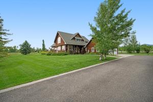 a house with a tree on the side of a road at Fun w/ Family! Mtn-View Gem w/ Deck in Driggs in Driggs