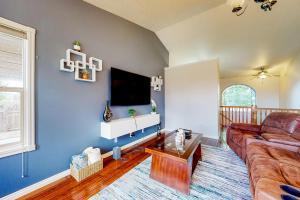 a living room with a couch and a flat screen tv at Hike, Golf & Explore: Driggs Home w/ Patio & Grill in Driggs