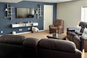 a living room with two couches and a tv at Hike, Golf & Explore: Driggs Home w/ Patio & Grill in Driggs +14 photos