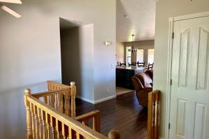a staircase leading to a living room and a kitchen at Hike, Golf & Explore: Driggs Home w/ Patio & Grill in Driggs