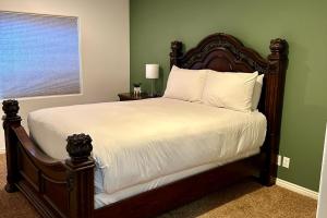 a bedroom with a bed with white sheets and a window at Hike, Golf & Explore: Driggs Home w/ Patio & Grill in Driggs
