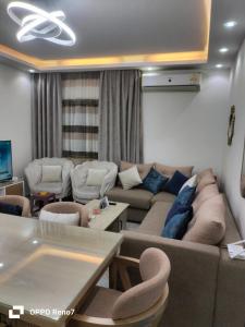 a living room with a couch and a table at Building 211, Gulf 2, Apartment 403 in ‘Ezbet `Abd el-Ḥamîd +15 photos