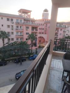 a balcony with a view of a parking lot at Building 211, Gulf 2, Apartment 403 in ‘Ezbet `Abd el-Ḥamîd