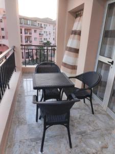 a balcony with a table and chairs on it at Building 211, Gulf 2, Apartment 403 in ‘Ezbet `Abd el-Ḥamîd