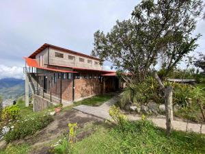 a house on the side of a hill at Inti Amanta Lodge in Sigchos