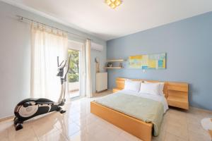 a bedroom with a bed and a exercise bike at Filerimos Dream Villa in Ialysos +41 photos