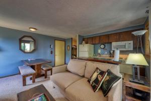 a living room with a couch and a kitchen at Slope-Side Getaway Deck Pool Table Views in Boise